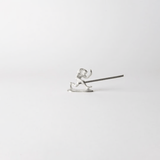 Chōjū-giga monkey-shaped incense holder made from cast tin, holding a lit incense stick in a minimalist white setting – inspired by Japan’s oldest picture scroll.