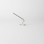 Chōjū-giga rabbit incense holder with incense stick inserted, handcrafted in pewter, capturing the dynamic motion of the leaping rabbit from Japan’s famous animal caricature scrolls.