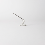 Chōjū-giga rabbit incense holder with incense stick inserted, handcrafted in pewter, capturing the dynamic motion of the leaping rabbit from Japan’s famous animal caricature scrolls.