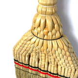 Close-up detail of the intricate handwoven straw pattern on the Shirokiya Denbei Edo Broom, showcasing the craftsmanship, tight braiding, and decorative red and black bands near the base.