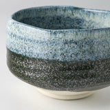 Close-up of the Seifu blue matcha bowl highlighting its textured hand-glazed surface, with layered blue and deep charcoal tones crafted in Mino ware tradition.