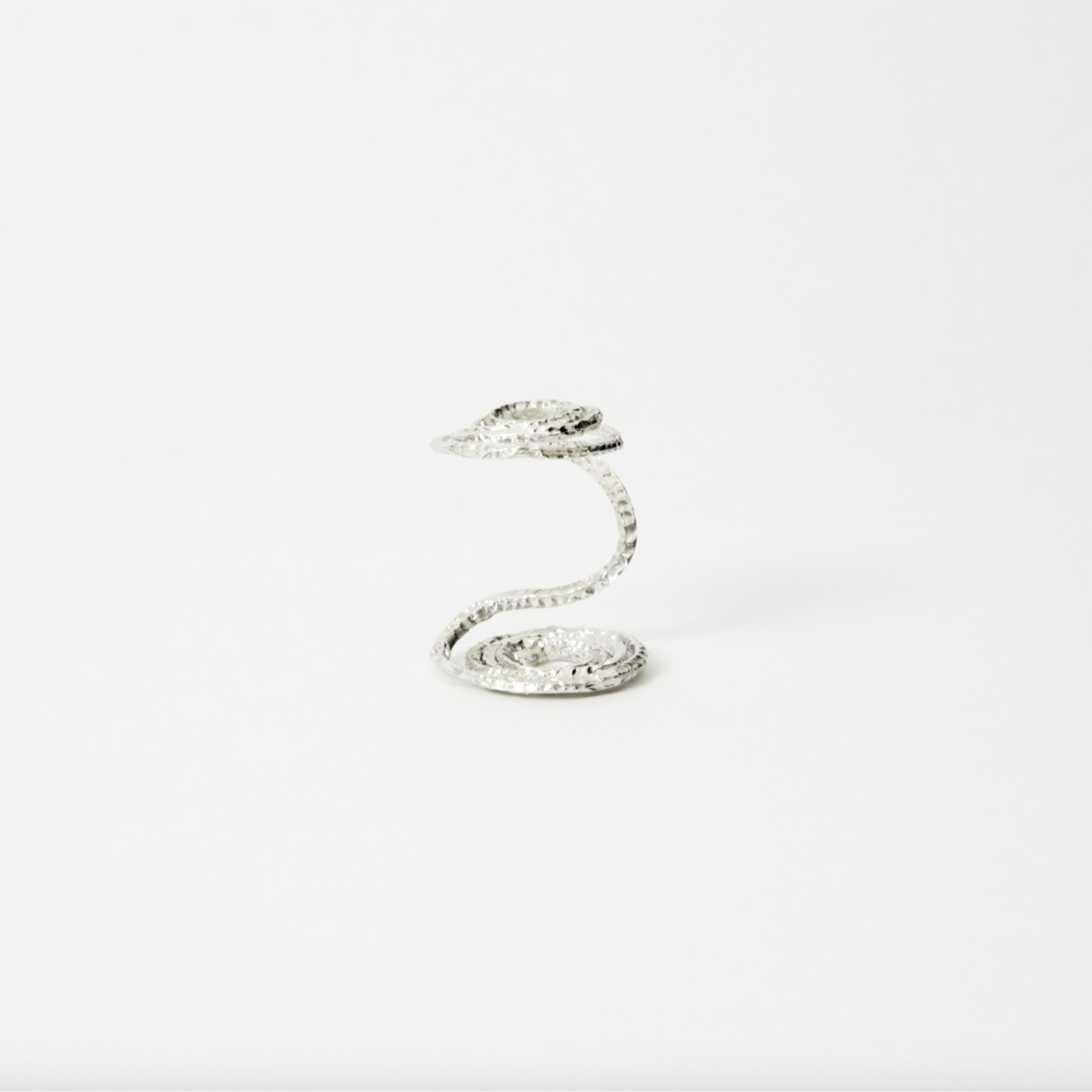 Elegant handcrafted silver spiral flower holder designed for minimalist ikebana and contemporary floral arrangements, perfect for elevating single stems or trailing plants in modern home decor. 