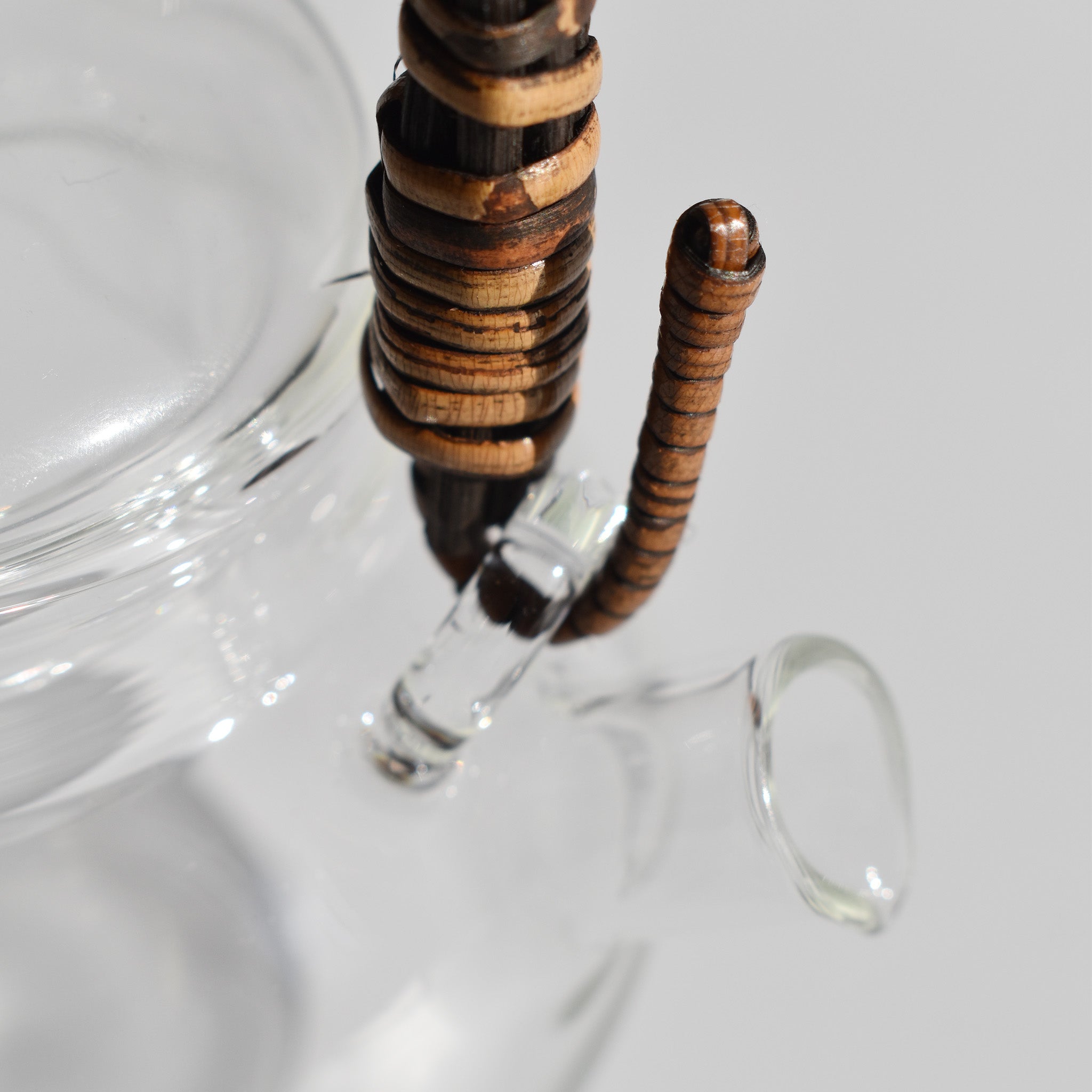 Close-up detail of glass kyusu teapot with rattan wrapped handle and clear side spout, 250ml Japanese tea pot.