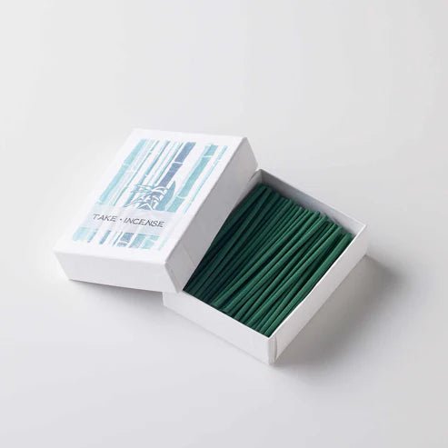 Open box of Japanese Hanga Bamboo incense showing neatly arranged green incense sticks with bamboo pattern on packaging