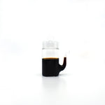Japanese glass soy sauce dispenser with smooth drip-free spout, filled with soy sauce.