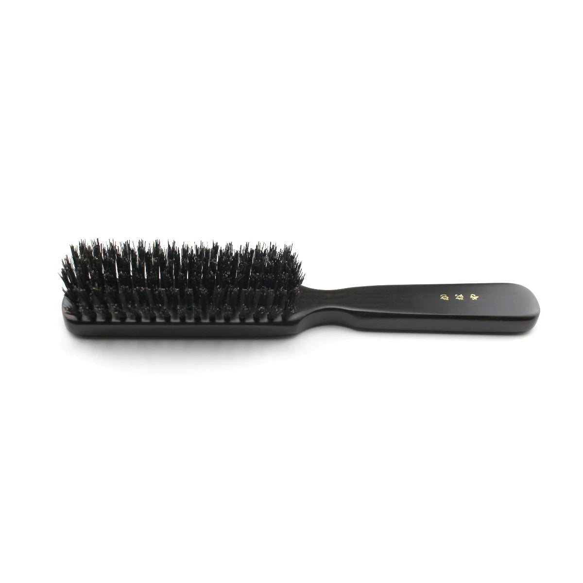 Side profile of a Kanaya medium-stiffness natural bristle hair brush, showcasing densely packed black bristles and a smooth black wooden handle with gold Japanese lettering, placed on a white background.