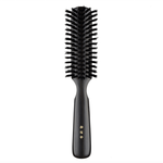 Japanese round hair brush featuring firm black natural bristles and a polished dark wood handle, crafted for smooth detangling and everyday grooming.