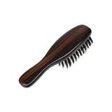 Back view of the Kanaya wild boar bristle travel brush, highlighting its smooth, contoured wooden handle with rich natural grain and elegant dark finish.