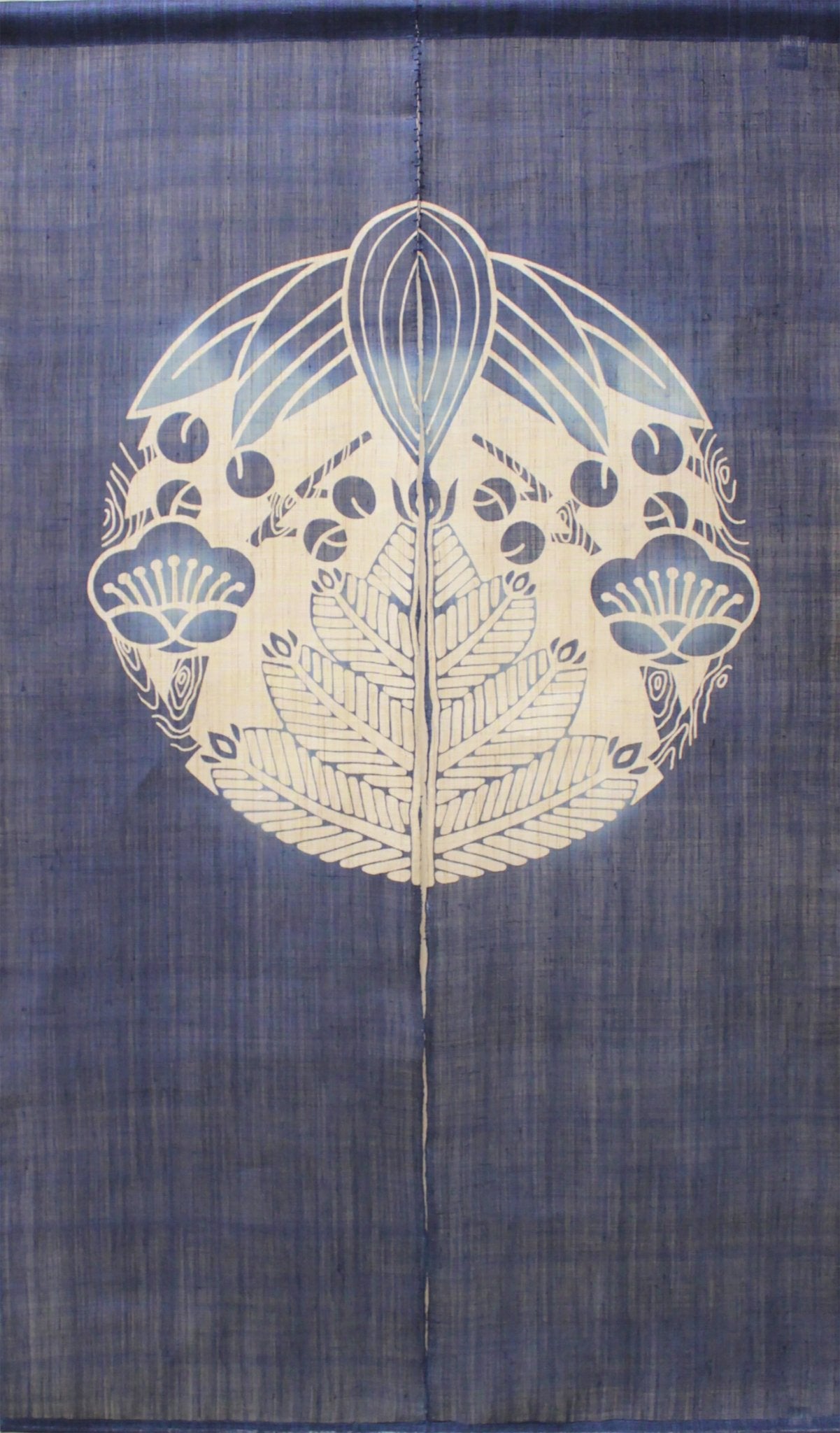 Close-up of Shochikubai noren curtain in indigo featuring pine, bamboo, and plum crest motif, traditional Japanese fabric panel.
