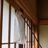 Traditional Japanese silk duster with white silk strips cleaning a wooden shoji screen.